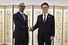 Prime Minister Kim Min-seok, right, poses for a photo with Michael Harris, vice chief of the New York Stock Exchange, during their meeting at the government complex in Seoul on March 23, 2026, in this photo released by Kim's office. [YONHAP]