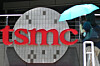 A woman walks past a Taiwan Semiconductor Manufacturing Company (TSMC) sign at the Hsinchu Science Park in Hsinchu on July 5, 2023. [AFP/YONHAP]