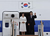 President Lee Jae Myung, right, and first lady Kim Hea Kyung wave as they depart for state visits to Singapore and the Philippines from Seoul Air Base in Seongnam, Gyeonggi on March 1. [JOINT PRESS CORPS]