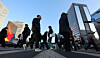 Morning commuters head to their offices in Gwanghwamun, central Seoul, on Feb. 19. [YONHAP]