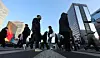 Morning commuters head to their offices in Gwanghwamun, central Seoul, on Feb. 19. [YONHAP]