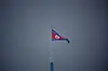 A North Korean flag flutters at the propaganda village of Gijungdong in North Korea, in this picture taken near the truce village of Panmunjom inside the demilitarized zone, separating the two Koreas, in South Korea on July 19, 2022. [REUTERS/YONHAP]