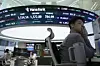 A currency trader watches monitors near a screen showing the Korea Composite Stock Price Index (Kospi) at the foreign exchange trading room of Hana Bank's headquarters in Jung District, central Seoul, on July 9, 2025. [AP]