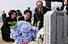 President Lee Jae Myung, second from left, and Kim Hea Kyung, left, pay tribute at the cemetery for those killed in the Second Battle of Yeonpyeong and the shelling of Yeonpyeong ahead of the 11th West Sea Defense Day ceremony at Daejeon National Cemetery on March 27. [JOINT PRESS CORPS]