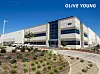 Olive Young distribution center building in Bloomington, California, under a clear blue sky.