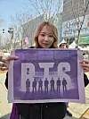 A fan poses with the BTS special edition of the Korea JoongAng Daily in central Seoul on March 21. [KIM MIN-YOUNG]