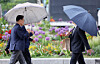 People holding umbrellas walk in central Seoul on May 11. [NEWS1]
