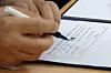 Samsung Electronics' management negotiator Yeo Myung-koo signs the tentative wage agreement in front of the press at the Ministry of Employment and Labor office in Suwon, Gyeonggi, on May 20. [NEWS1]