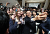 President Lee Jae Myung takes a selfie with foreigners at the National Museum of Korea in Yongsan District, central Seoul on Feb. 26. [JOINT PRESS CORPS]