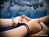 A graphic illustration of a criminal suspect being handcuffed. [JOONGANG ILBO]