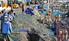 Fishermen and migrant workers shake freshly caught spring anchovies from their nets at Daebyeon Port in Gijang County, Busan, on April 7, 2025. [SONG BONG-GEUN]
