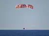 A handout photo made available by the National Aeronautics and Space Administration (NASA) shows NASA's Orion spacecraft 'Integrity' as it descends by parachute in the Pacific Ocean, 10 April 2026. The mission, crewed by NASA astronauts Reid Wiseman, commander, Victor Glover, pilot, Christina Koch, mission specialist, and CSA (Canadian Space Agency) astronaut Jeremy Hansen, mission specialist, completed a flyby of the Moon and returned to Earth. [EPA/YONHAP]