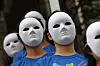 Officials from the Blue Tree Foundation, a non-governmental organization focused on school violence, wear “masks of indifference” during a performance at a press conference announcing the 2023 nationwide survey on school violence, cyberbullying and related measures held in Seocho District, southern Seoul, on Sept. 12, 2023. [YONHAP]