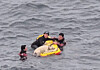 Coast Guard officers rescue a pet dog that fell into the sea near Sojeongbang Falls in Seogwipo, Jeju, on May 27. [SEOGWIPO COAST GUARD]