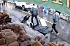 A man and his wife are seen with a suitcase that was later found to have carried the body of the man's mother-in-law, in this CCTV footage from a shop on a street where the pair passed by in Daegu on March 18. [YONHAP]