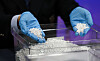 An official shows seized silver ahead of a briefing on intensified crackdowns following an increase in silver smuggling at Incheon Airport Regional Customs in Incheon, on April 8. [NEWS1]