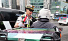 A police officer talks to a motorbike rider in Gangnam District, southern Seoul, on July 15, 2025. [YONHAP]