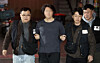 A suspect accused of fatally stabbing an airline captain at an apartment building in Busan, center, is transferred to the Busan Busanjin Police Station on March 17. [NEWS1]
