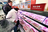 People buy pork at a grocery store in central Seoul on Feb. 26. [NEWS1]