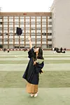 Maria Teresa Dyani throws her cap into the air during her graduation at Kyungsung University. [MARIA TERESA DYANI]