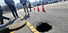 A sinkhole is seen on a road near the government complex in Eojin-dong, Sejong, on March 23. Police controlled the road while Sejong officials discussed response measures. [NEWS1]