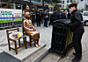 Police officers remove the barricade surrounding the statue symbolizing the victims of Japan's wartime sexual slavery in central Seoul on April 1. [YONHAP]