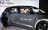 Transport Minister Kim Yun-duk, right, rides in an autonomous vehicle during a business agreement ceremony for Korea’s autonomous driving team held in Gwangju on May 13. [YONHAP]