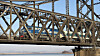 A passenger train bound for Beijing crosses the Sino-Korean Friendship Bridge over the Yalu River between North Korea and China on March 12, the first day of passenger rail service between the two countries in six years. [YONHAP]