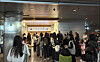 Korean nationals wait in line to board a special commercial flight arranged by Qatar for their return home on March 9. [YONHAP]