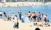 People cool off from the heat at Gwangalli Beach in Suyeong District, Busan, on the afternoon of May 31, as the city's daytime temperature hovers around 30 degrees Celsius. [YONHAP]