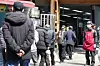 People wait in a long line for free meals outside a soup kitchen near Tapgol Park in Jongno District, central Seoul, on March 24, 2025. [NEWS1]