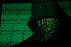 A projection of cyber code on a hooded man is pictured in this illustration picture taken on May 13, 2017. [REUTERS/YONHAP]