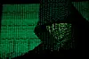 A projection of cyber code on a hooded man is pictured in this illustration picture taken on May 13, 2017. [REUTERS/YONHAP]