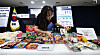 An official from the Ministry of Intellectual Property displays examples of copycat food and beverage products ahead of a briefing on the introduction of a government certification system for well-known Korean brands at the Government Complex in Jongno District, central Seoul, on March 31. [YONHAP]