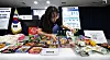 An official from the Ministry of Intellectual Property displays examples of copycat food and beverage products ahead of a briefing on the introduction of a government certification system for well-known Korean brands at the Government Complex in Jongno District, central Seoul, on March 31. [YONHAP]