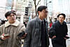 Rep. Jang Kyung-tae of the ruling Democratic Party, center, enters the Seoul Metropolitan Police Agency in the capital to attend an investigation on March 19. [YONHAP]