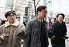 Rep. Jang Kyung-tae of the ruling Democratic Party, center, enters the Seoul Metropolitan Police Agency in the capital to attend an investigation on March 19. [YONHAP]