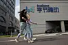 Women wearing masks to pass by the headquarters of ByteDance, owners of TikTok, in Beijing, China, Aug. 7, 2020. [AP/YONHAP]