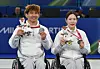 Baek Hye-jin, right, and Lee Yong-suk pose after winning a silver medal in the mixed doubles curling event at the 2026 Milan-Cortina Winter Paralympics in Italy on March 11. [NEWS1]