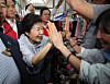 Former President Park Geun-hye highfives with a member of the public while visiting Jungang Market in Jinju, South Gyeongsang, on May 27. [NEWS1]