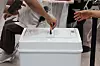 An eligible voter puts their ballots inside the ballot box while voting for the 2026 local elections at a polling station in Dongjak District, southern Seoul, on June 3. [YONHAP]
