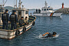 An AI-generated image of a man escaping from a boat by swimming [CHATGPT]
