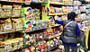 A shopper picks up a confectionary product at a large supermarket in Seoul on March 12. [NEWS1]