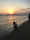 Me when I was in first grade, touching seawater in front of a sunset in Dadaepo Beach. [LEE EUNJAE]