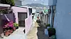 A view framed by pastel-toned homes in Bongsan Village, Bongnae-dong, Yeongdo District, shows the water and mountains on May 5. [WOO JI-WON]