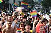 Participants at the Seoul Queer Culture Festival wave rainbow flags and signs as they walk from Jonggak Station in Jongro District, central Seoul, to Euljiro, on June 14, 2025.