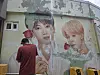 A mural of BTS members Jungkook and Jimin at Gamcheon Culture Village is undergoing restoration. [JIN EUN-SOO]