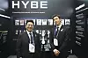 HYBE Chairman Bang Si-hyuk, left, and BTS member RM visit the HYBE promotional booth during the opening ceremony of the APEC CEO Summit at the Gyeongju Arts Center in North Gyeongsang on Oct. 29, 2025. [YONHAP]