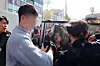 A so-called drunk-driving hunter YouTuber gets into a police transport vehicle after attending a pretrial detention hearing at Gwangju District Court on the morning of Nov. 13, 2024. The YouTuber was brought in for the hearing after being booked on charges of jointly creating danger on the road by mobilizing several vehicles with subscribers to stop a car suspected of drunk driving. [YONHAP]