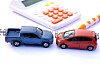 An image of two cars about to collide and a calculator [SHUTTERSTOCK]